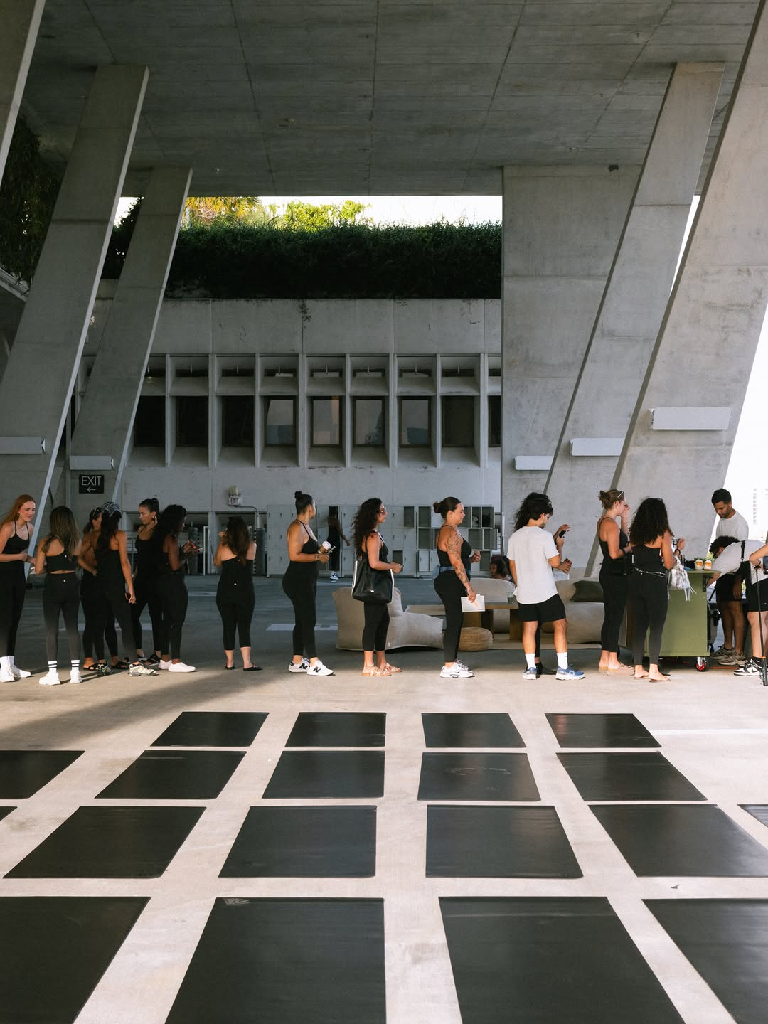 Line of guests at the Town bar under a concrete canopy