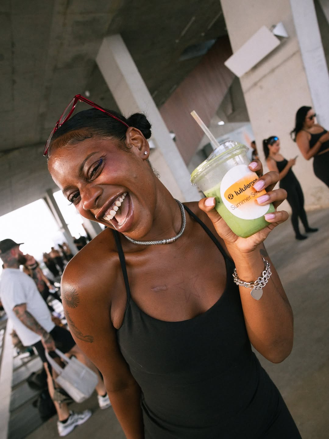 Smiling guest raising a Town matcha at lululemon Summer Series