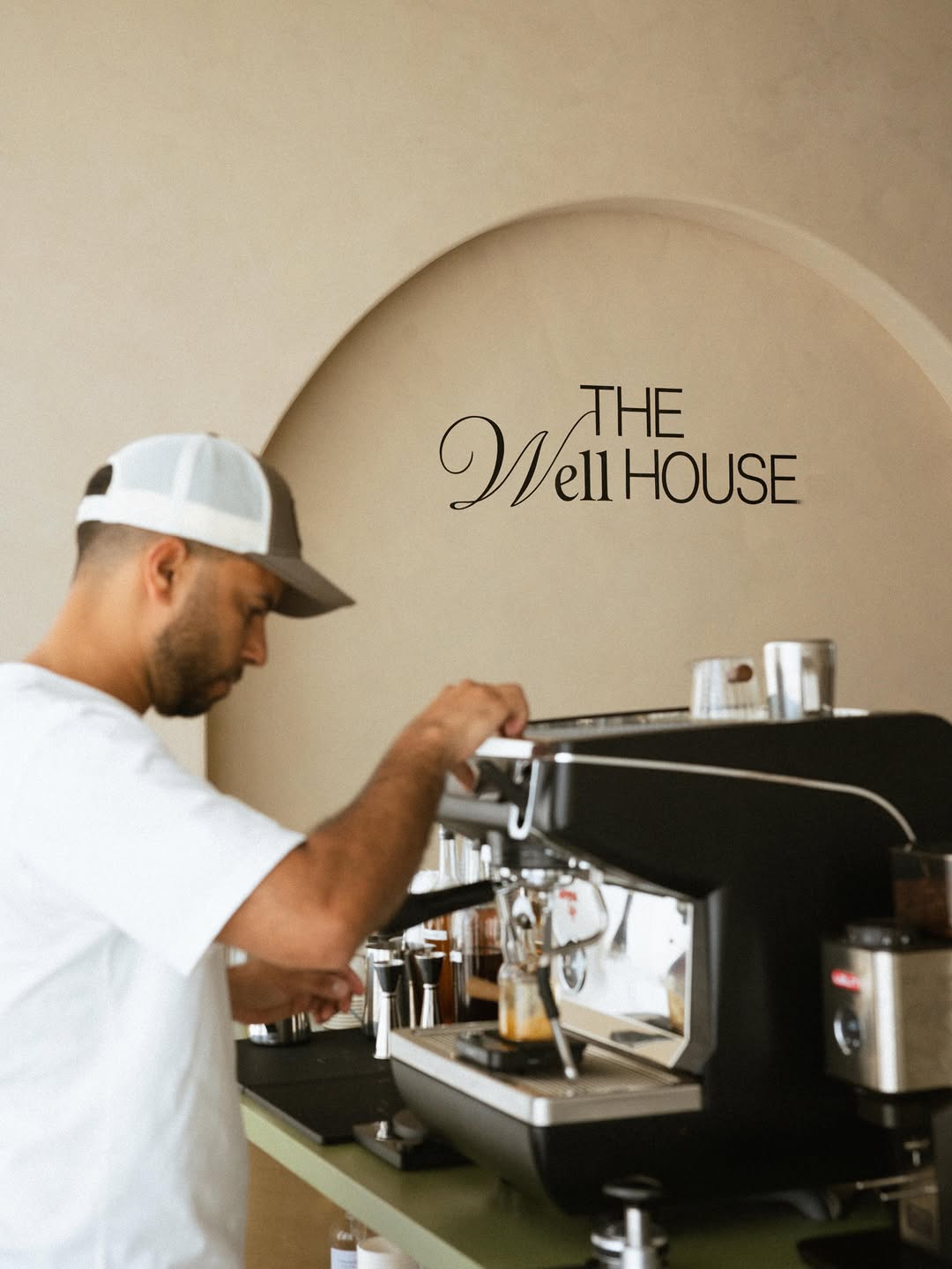 Town barista working an espresso machine at The Well House